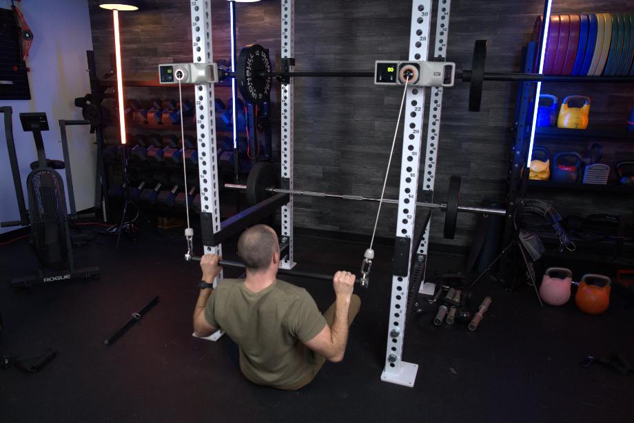 Coop uses dual Beyond Power Voltra I machines to do lat pulldowns.