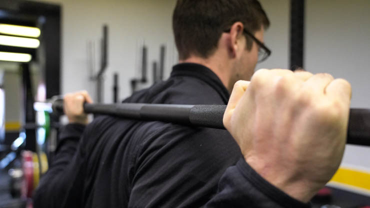 man using a barbell