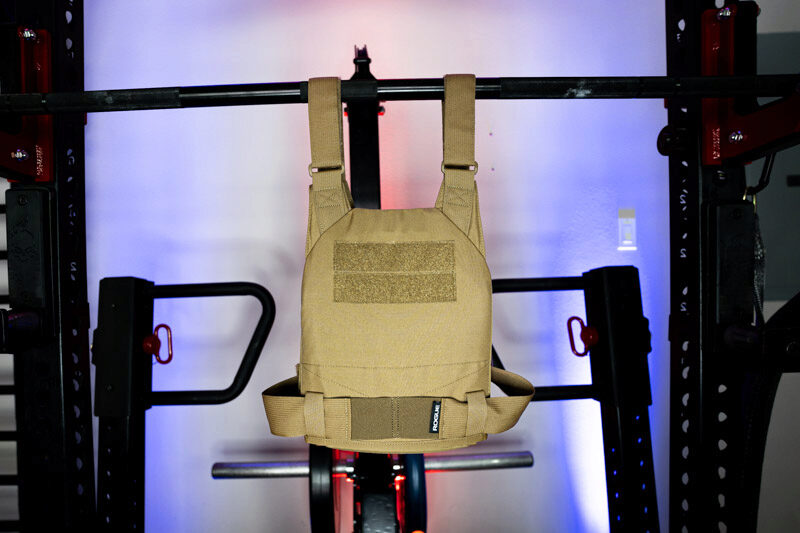 The Rogue Plate Carrier hanging on a pull-up bar