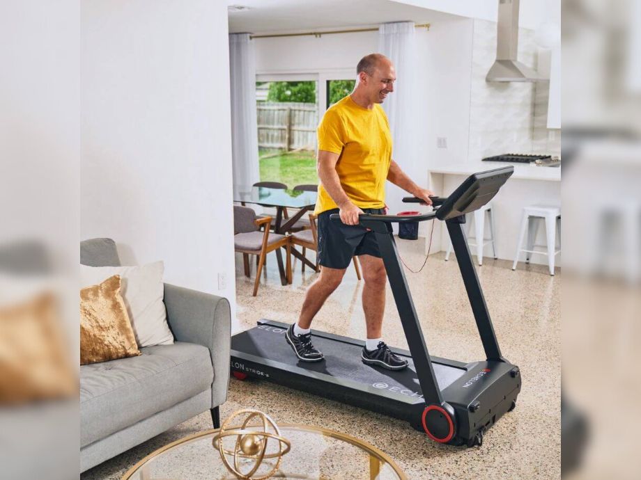 Man in yellow shirt running on the Echelon Stride-S treadmill