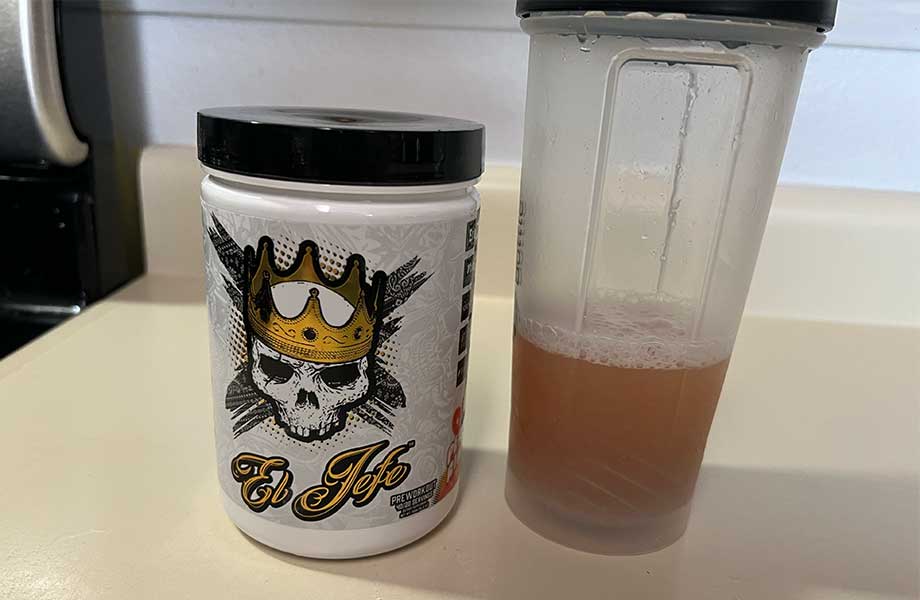A freshly mixed shaker of El Jefe Pre-Workout next to the container.