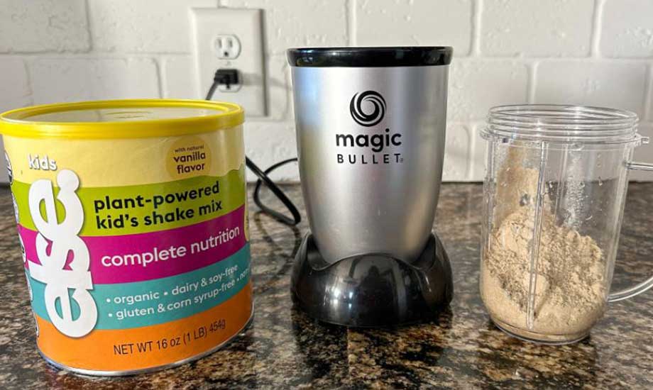 A container of Else Nutrition protein powder next to a blender and cup