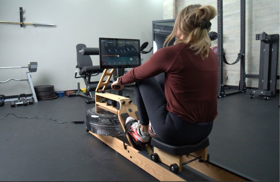 Woman using game-based workout on Ergatta Lite