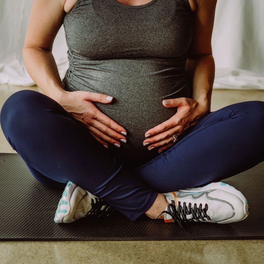 An image of a pregnant woman holding her stomach