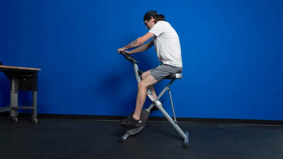 An image of a man riding the Exerpeutic folding magnetic exercise bike