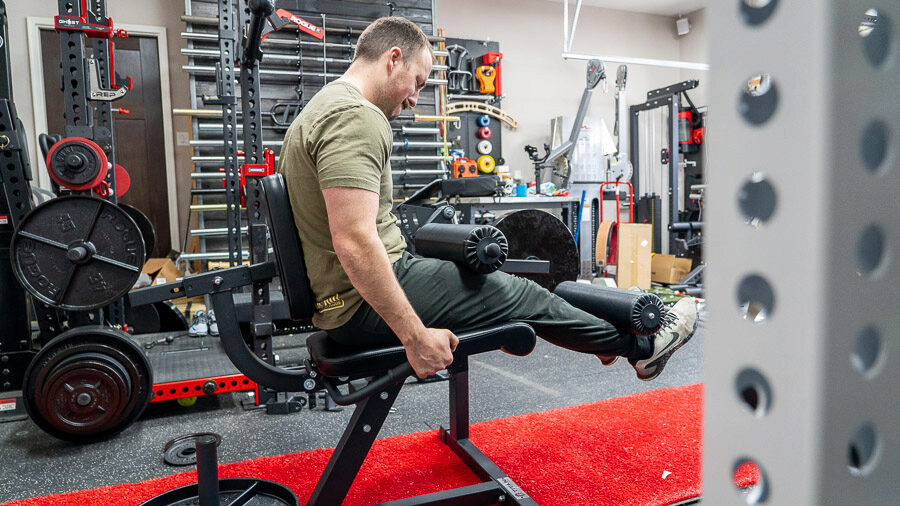 Profile view of Coop using Titan seated Leg Curl/Extension 