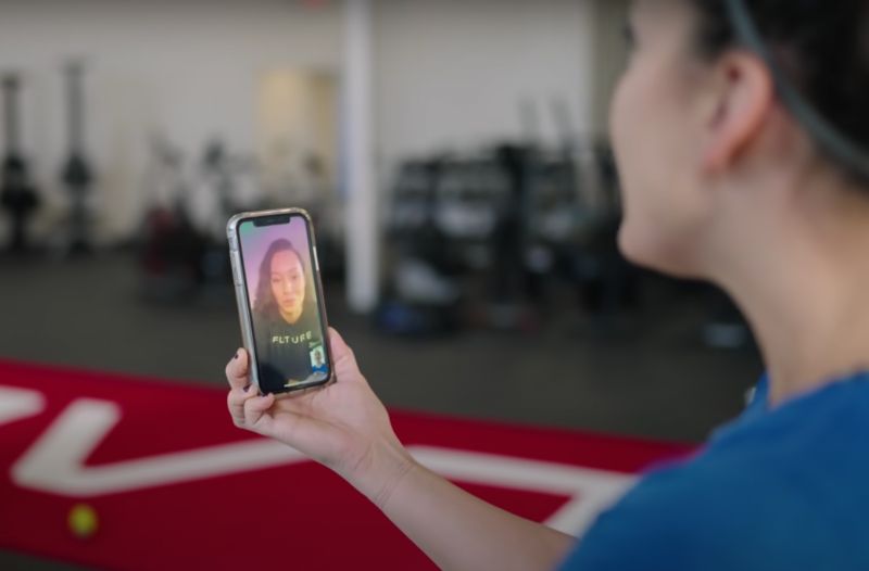 Woman FaceTiming with her online personal trainer