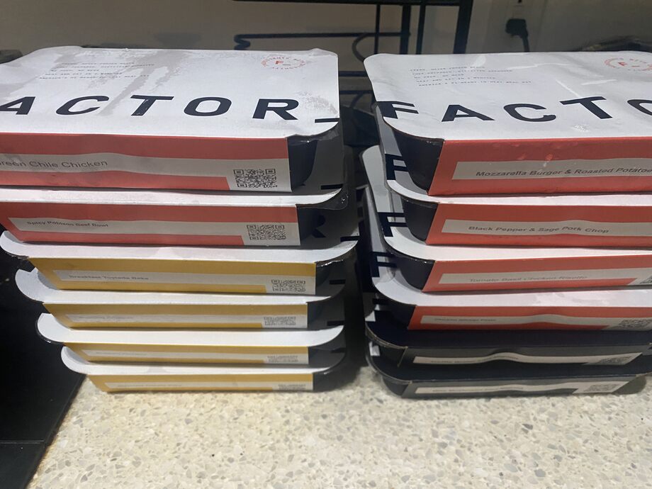 Stack of Factor meals on a counter