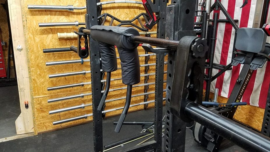 A safety squat bar in a squat rack