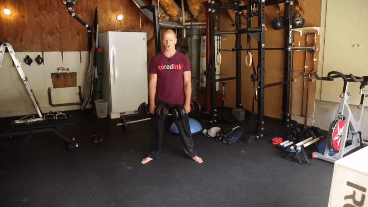 Tim Ferriss using dumbbells in his garage gym