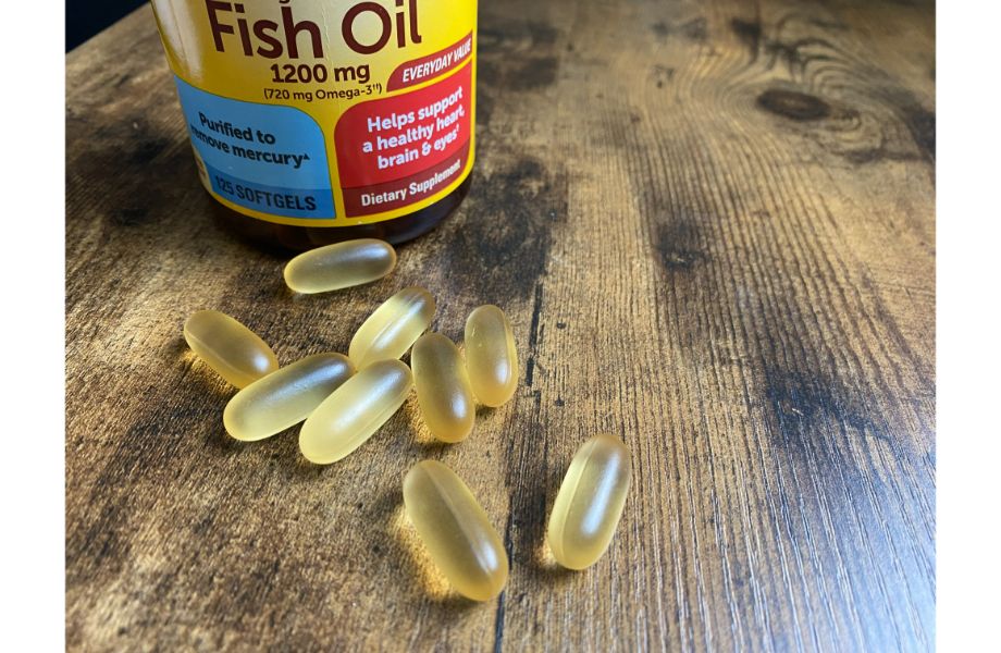 fish oil roundup feature photo capsules next to bottle on counter