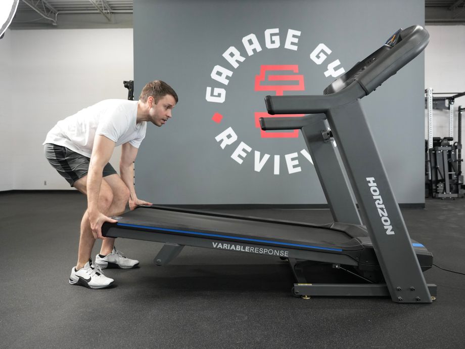 Man folding up the Horizon 7.4 Studio treadmill