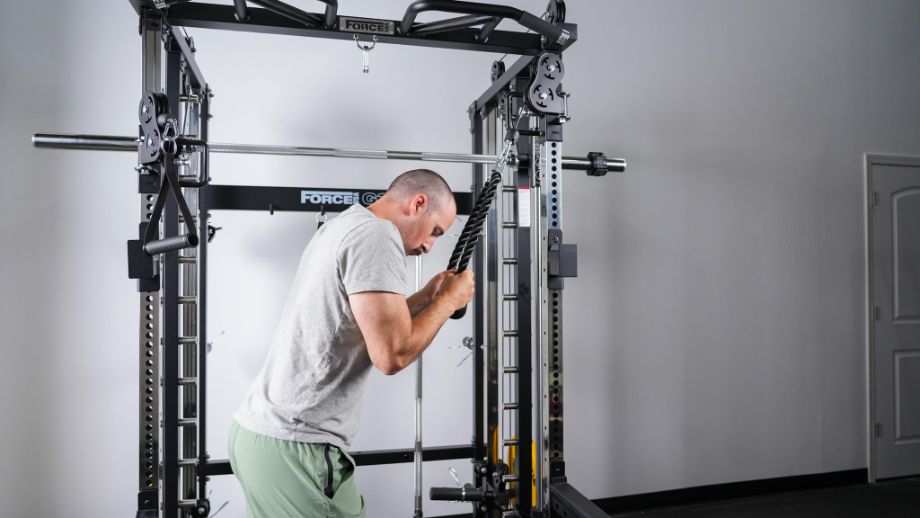 Man performing tricep push-downs with the Force USA G3