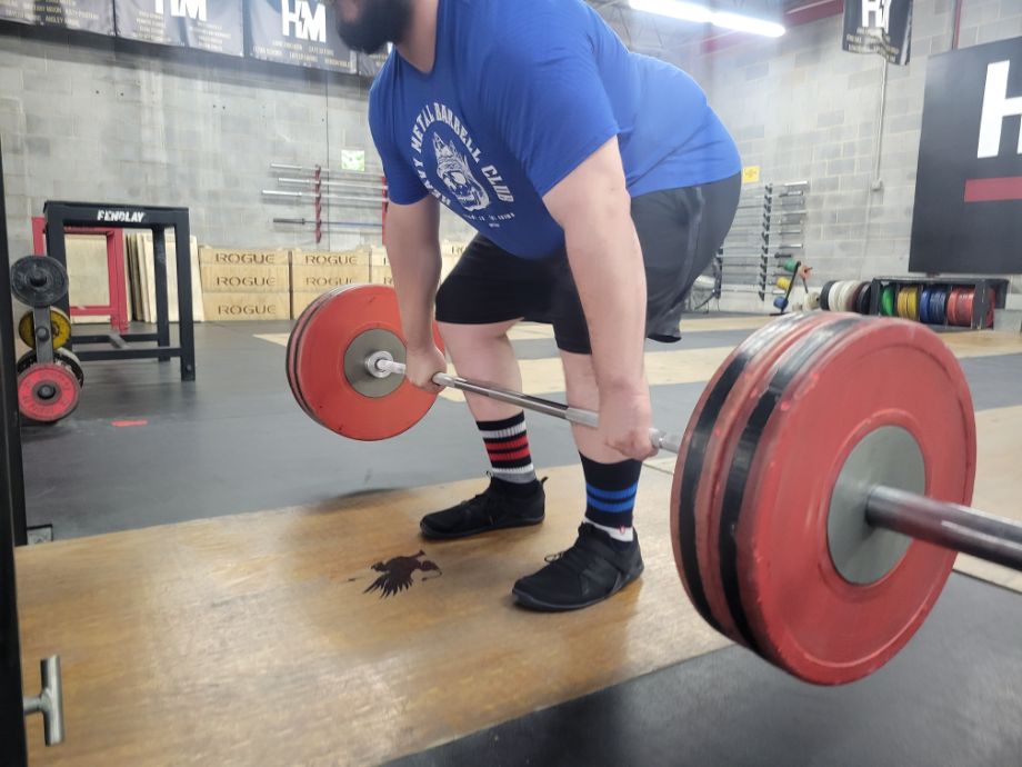 Man deadlifting with the Xero Shoes Forza Trainers