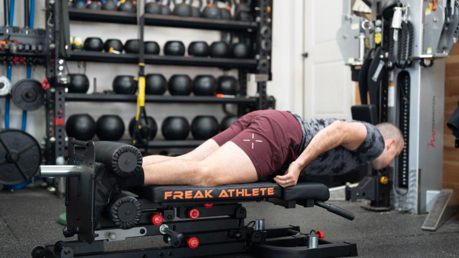 Coop performing Nordic curls on the Freak Athlete Nordic Hyper GHD weight bench