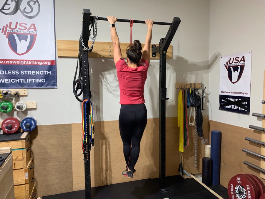 Woman doing pull-ups using a Fringe Sport Latex-Free Resistance Band