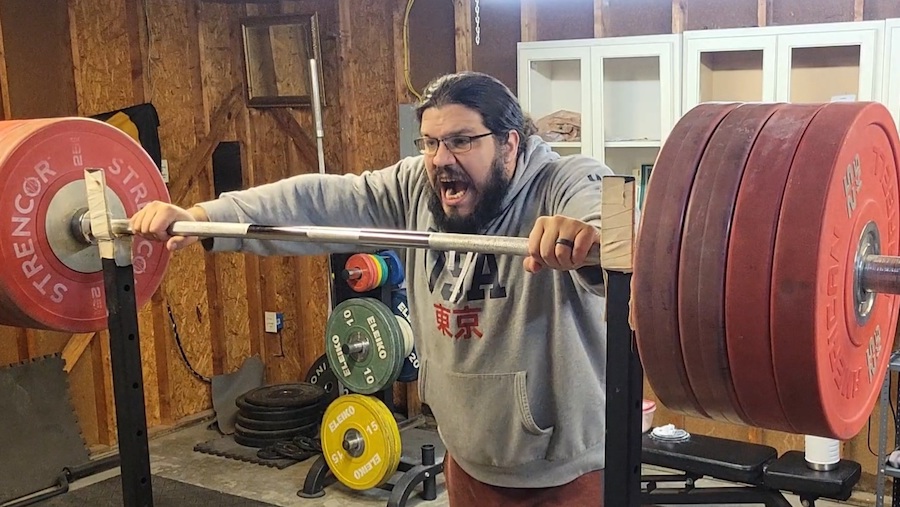 An image of a man getting hyped to squat