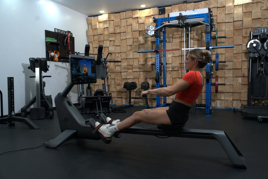 Woman rowing using the Peloton Row
