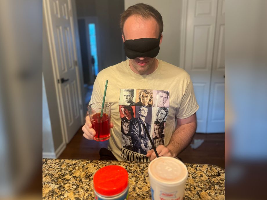 A blindfolded man comparing Ghost Aminos to a Sonic drink