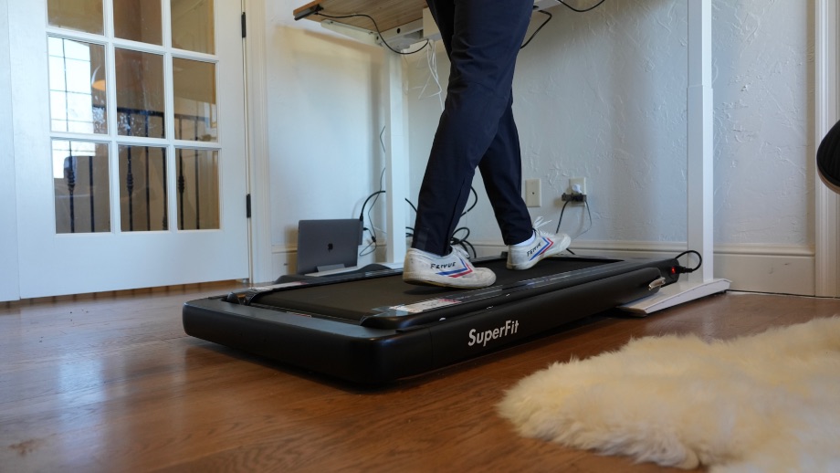 Coop walking on the Goplus treadmill in his office.