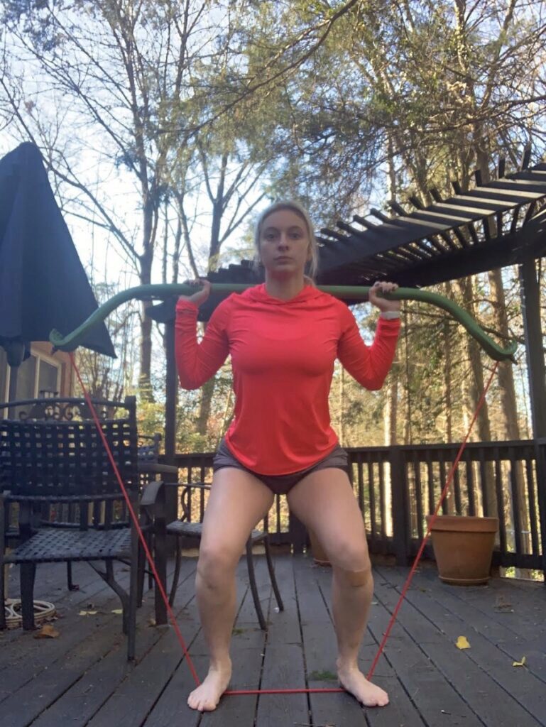 Caroline doing a squat with the Gorilla Bow.