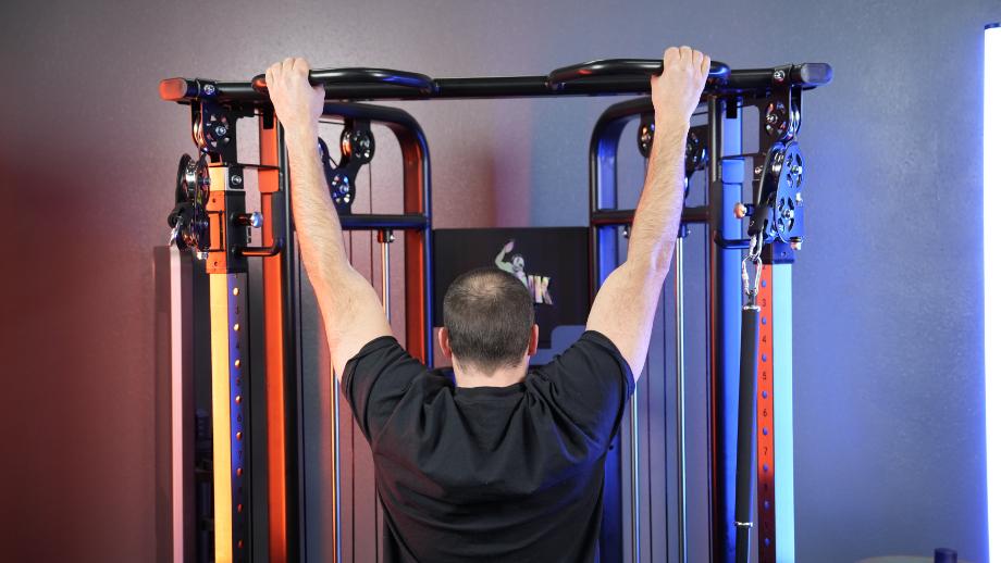 Coop uses the pull-up bar on a Gronk Fitness Functional Trainer.