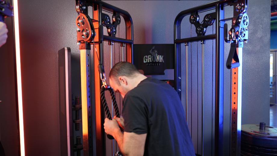 Coop does tricep push-downs on the Gronk Fitness Functional Trainer.