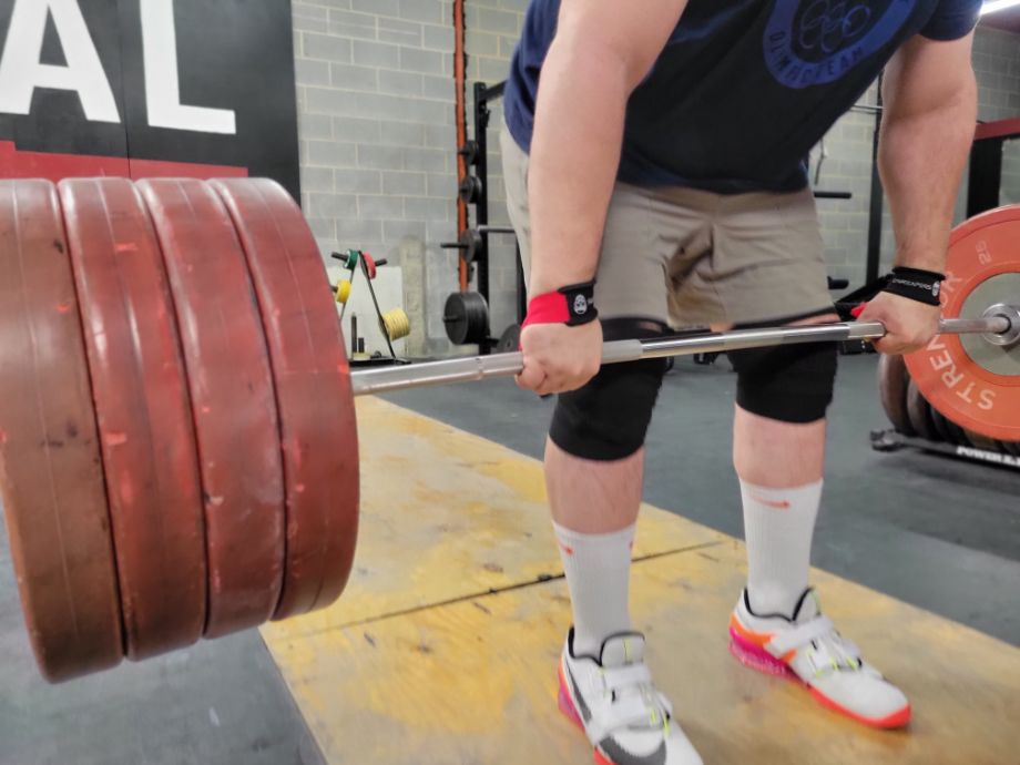 Man deadlifting with the Gymreapers Liftng Straps