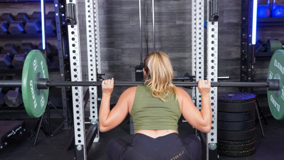 Woman using the Helios Squat Bar for squats