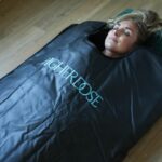 Woman using the Higher Dose Infrared Sauna Blanket