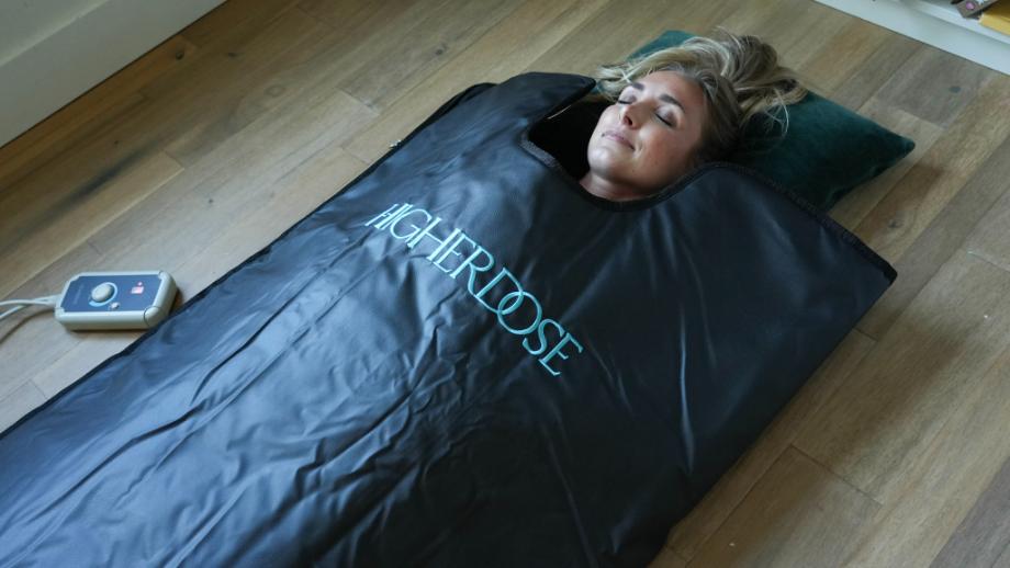 Woman using the Higher Dose Infrared Sauna Blanket