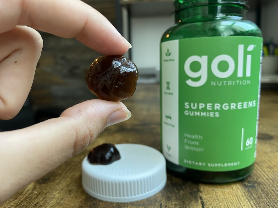 Holding A Goli Greens Gummy