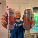 Our tester holds up cans of some of the best energy drinks.