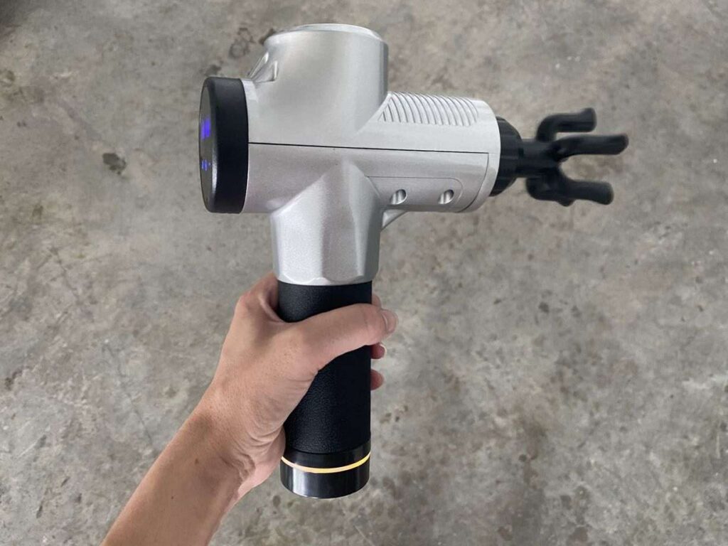 Holding the Chirogun massage gun