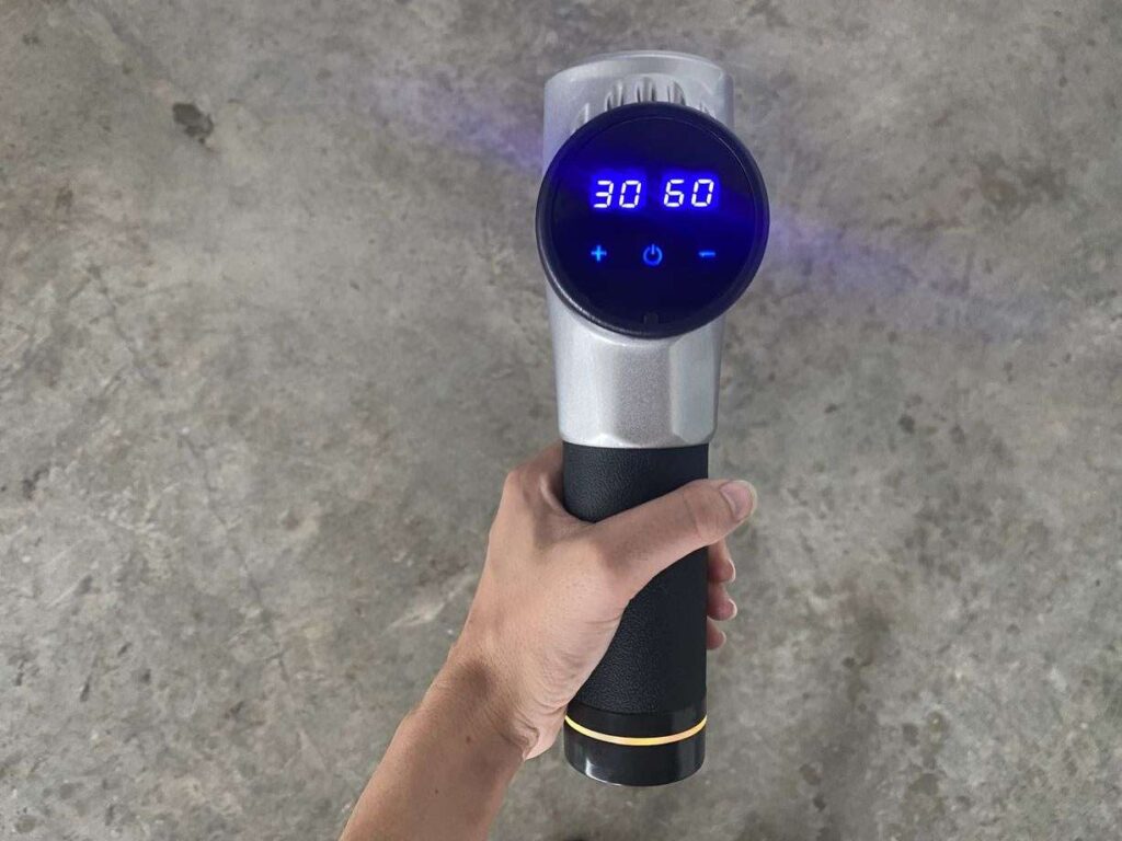 Holding the Chirogun massage gun