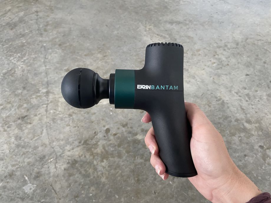 holding the Ekrin Athletics BANTAM mini massage gun