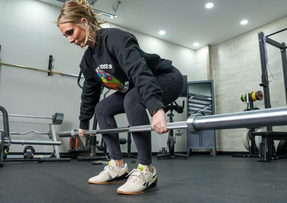 A person is shown lifting weights