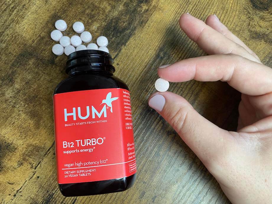 An image of Hum Nutrition B12 Turbo tablets in someone's hand