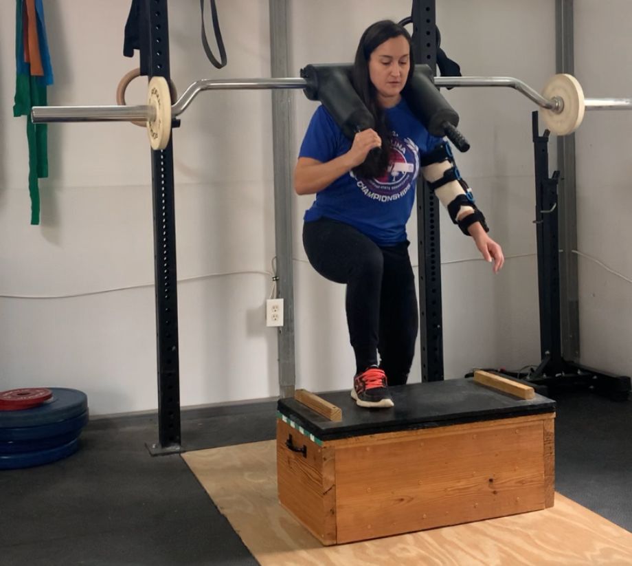 Woman using Titan Safety Squat Bar