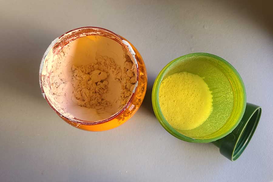 Inside view of a container of NOW soy protein and a shaker cup
