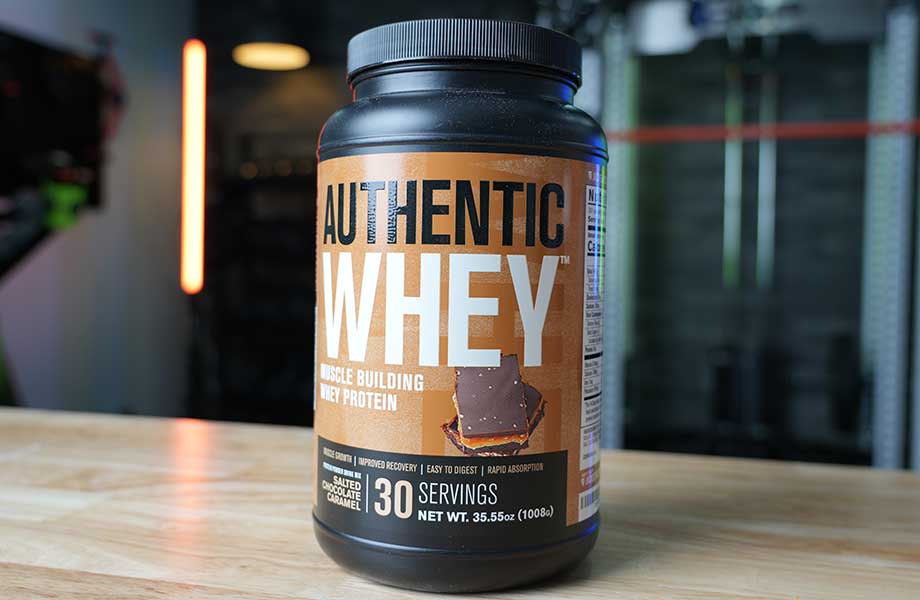 Close up of the front label on a container of Jacked Factory Authentic Whey protein powder.