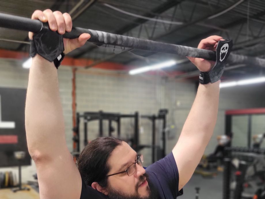 Man wrapping up for pull-ups with JerkFit Death Grips