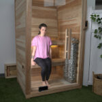 Our tester Jess sits on the bottom bench in a Plunge Sauna Mini
