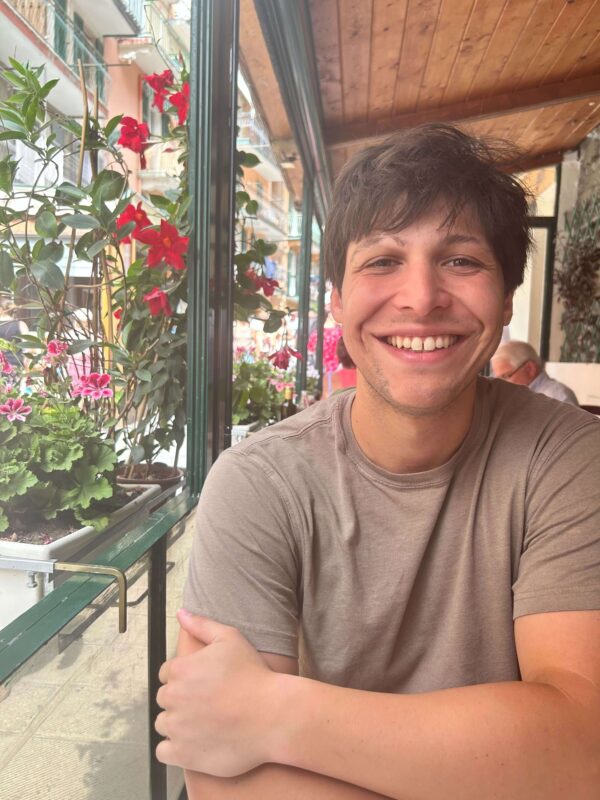 man smiling at a restaurant table