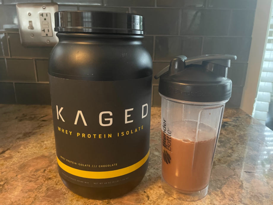 A shaker cup half-full of mixed Kaged Whey Protein Isolate