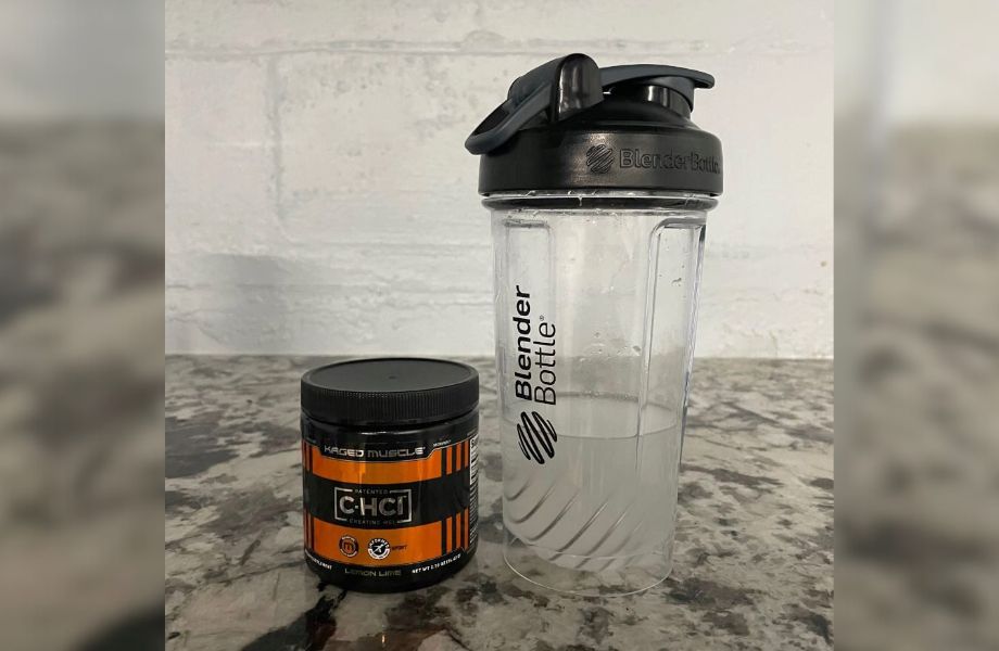 A shaker cup half full of Kaged Muscle Creatine