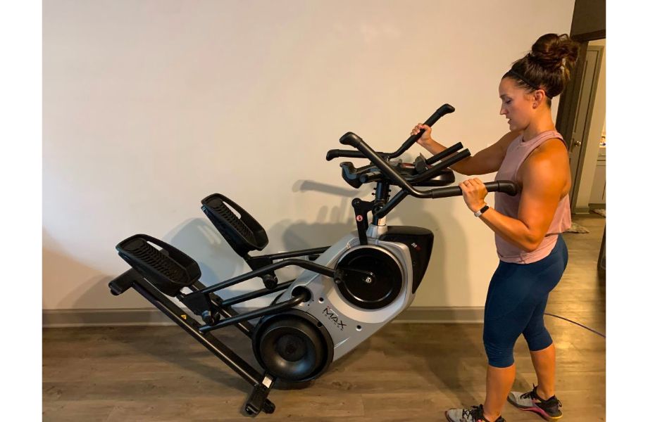 Woman moving an elliptical