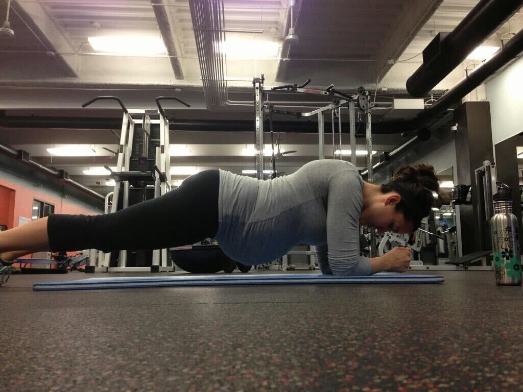 An image of a woman planking while pregnant