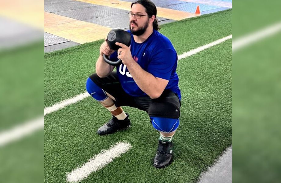 Man doing a kettlebell squat goblet squat