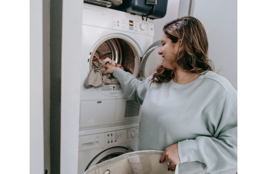 best laundry detergent for sweaty clothes woman doing laundry